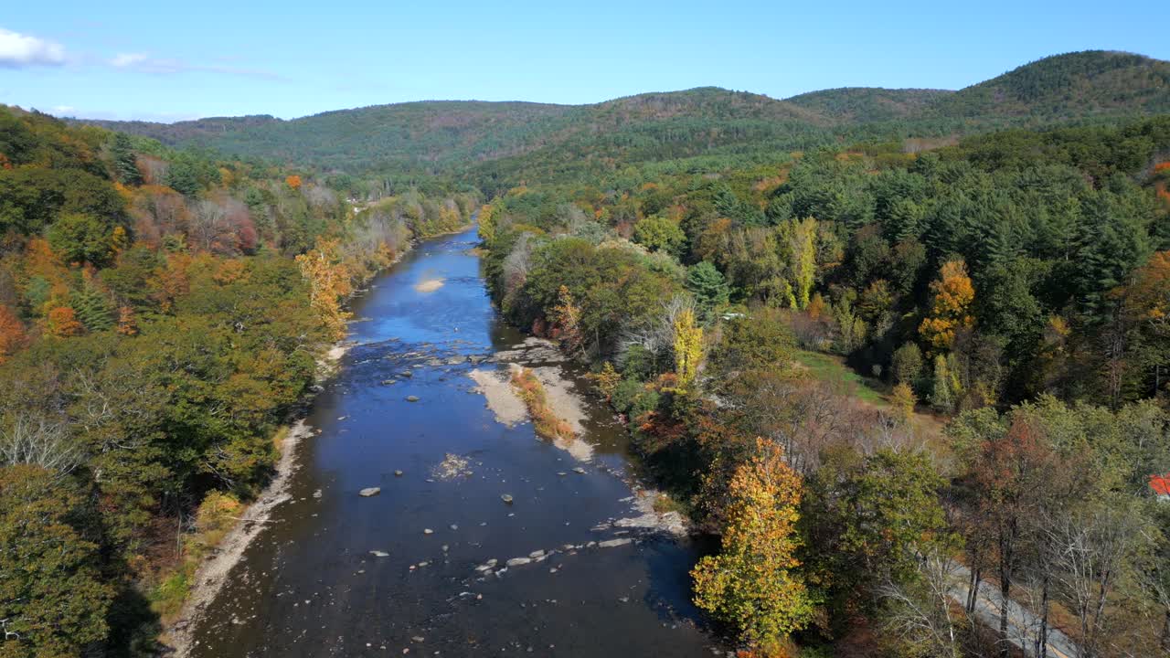 Angled flyover of forested riverine backdrop of West River, Green Mountains Vermont USA