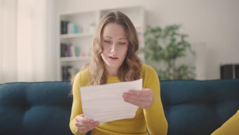 nervous young woman reading important letter, upset with bad news, failure