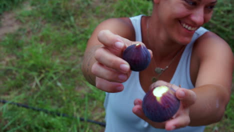 closeup of a caucasian woman showing handful of fresh figs