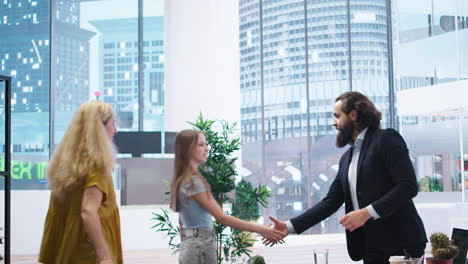 portrait of cheerful financial advisor in office meeting with clients