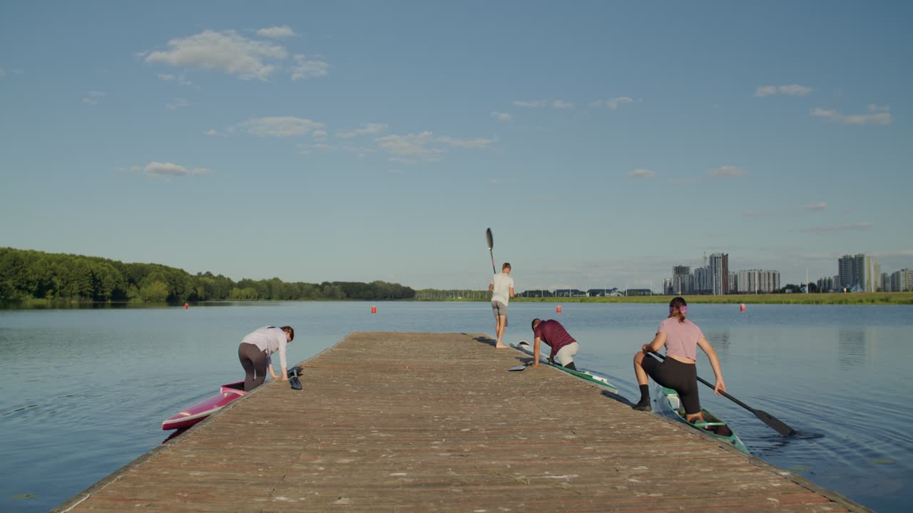 Rowing Team Preparing on a Pier by the Lake