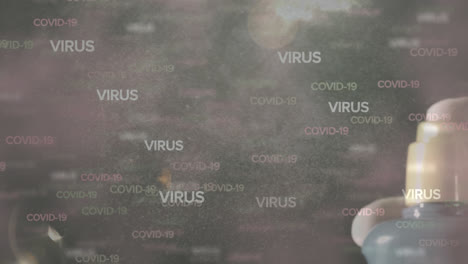 texto de covid-19 y virus contra la mano usando rociador