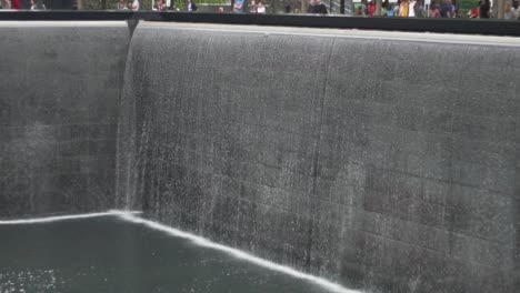 north pool at september 11 memorial and museum, new york usa. fall slow motion