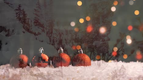 Animation-of-red-christmas-baubles,-fairy-lights-over-winter-scenery