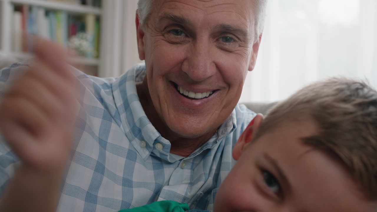 grandfather and child having video chat little boy sharing vacation weekend with family grandpa enjoying chatting on mobile technology at home with grandson pov 4k