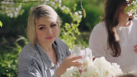 happy-woman-is-having-fun-in-garden-party-enjoying-cocktails-and-sunny-spring-weather-in-orchard