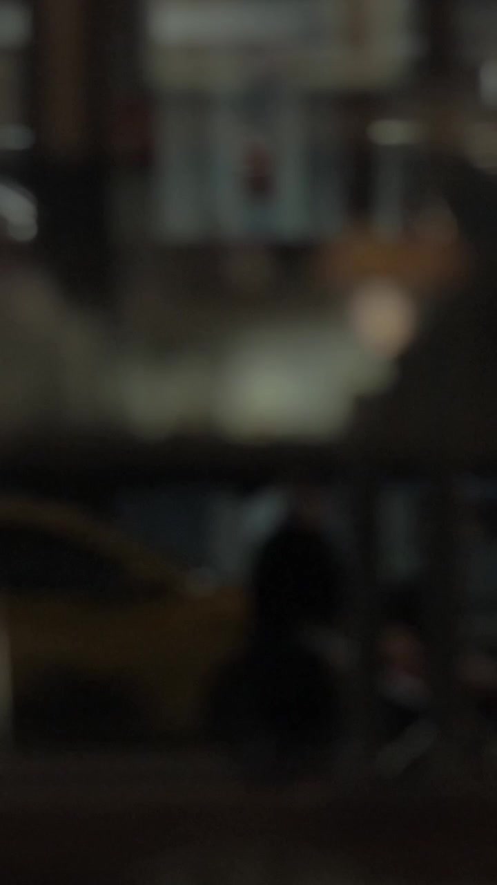 Night city street with car traffic and people on sidewalk, defocus