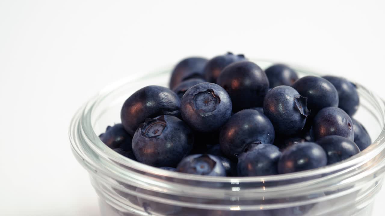 Blueberries in Glass Bowl Moving Across White Background Loop
