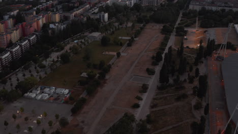 Aerial-view-of-public-park-and-surrounding-housing-estate.-Forwards-fly-above-city-in-morning.-Berlin,-Germany