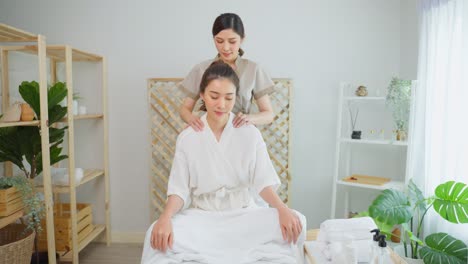 woman receiving a shoulder massage at a spa