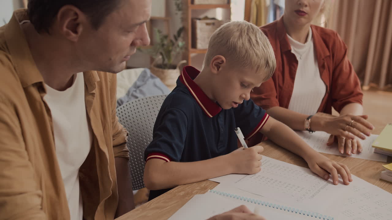 Teenage Son Listening to Parents Helping Him to Do Homework