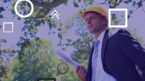 animation of shapes, caucasian engineer wearing helmet and holding blueprint looking at site