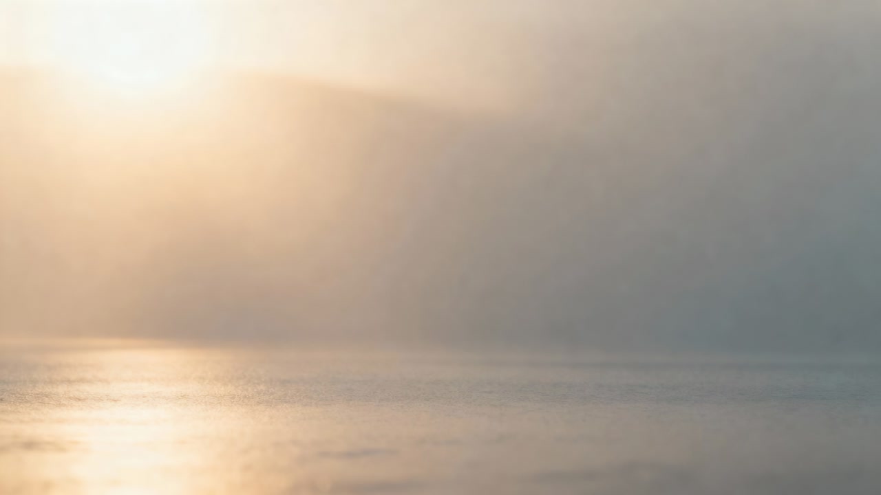 Haze softening light, sun spreading glow and lighting reflection on calm sea at horizon, copy space
