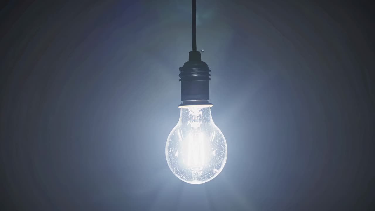 A dimly lit bulb hangs in the center, captured from a low angle