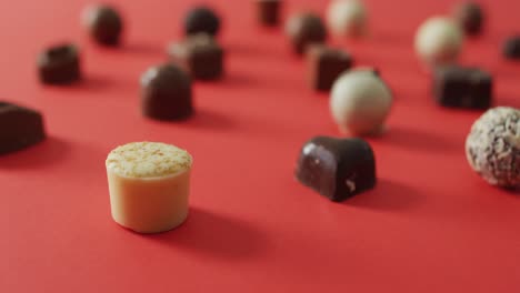 black and white chocolates on pink background at valentine's day