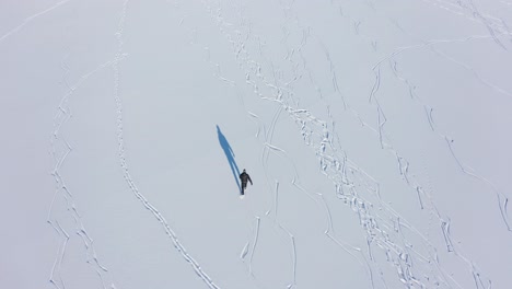 aerial view of tough figure ice skating at stamnes vestland norway - top down aerial