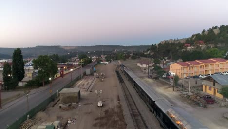 Aerial-drone-shot-of-the-El-Chepe-passenger-train-in-Creel,-Chihuahua,-Mexico