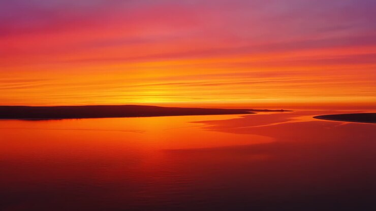 Vibrant Sunset Over River Estuary with Colorful Sky Reflection