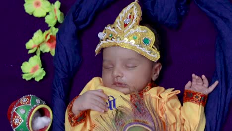 newborn baby boy in krishna dressed with props from unique perspective in different expression