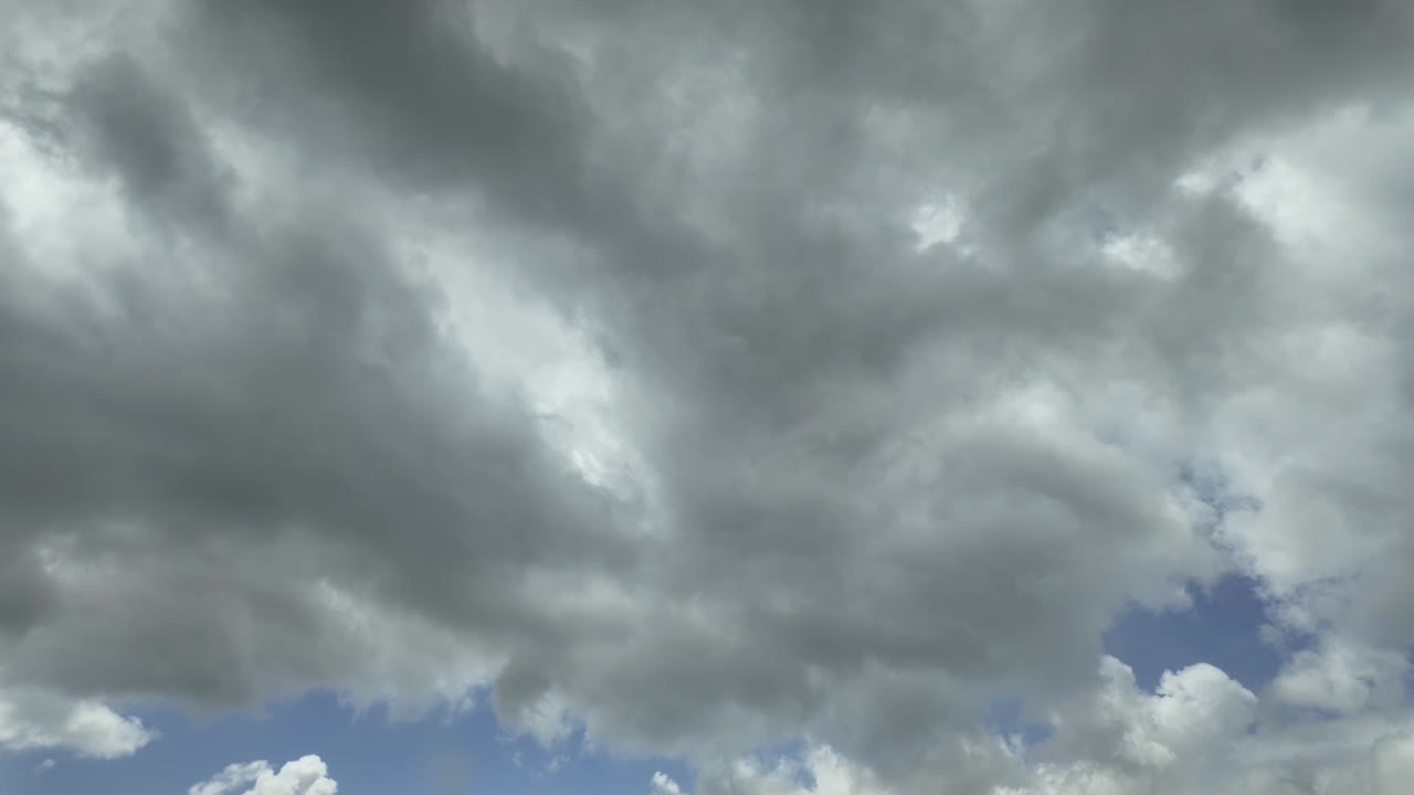 Ominous grey clouds moving over patches of blue sky, Cape Town, South Africa.