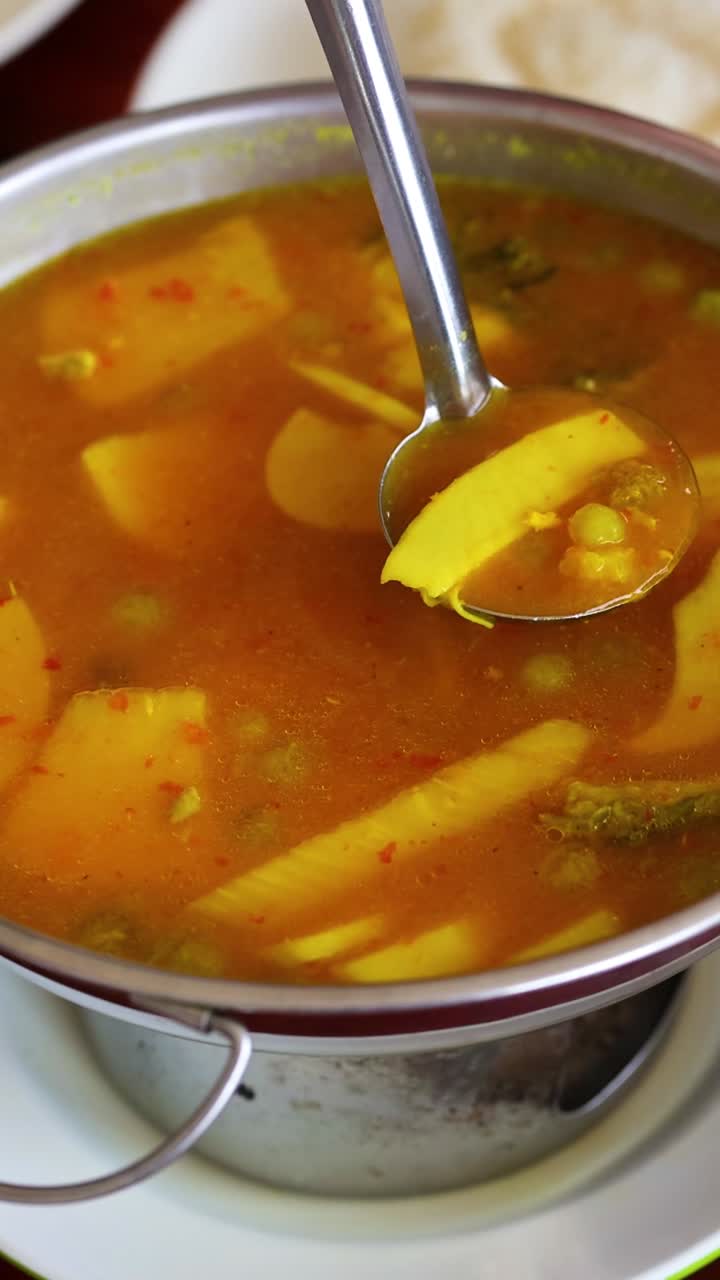 echando sopa en un cuenco en una mesa