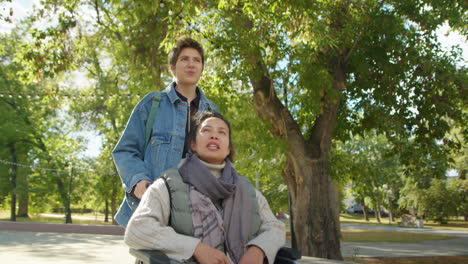 woman in wheelchair with friend in park