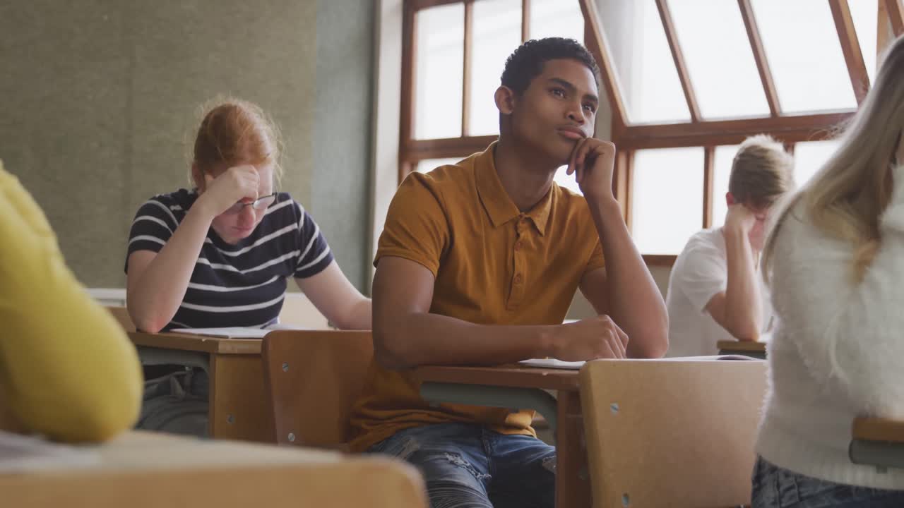 Mixed race boy thoughtful in class
