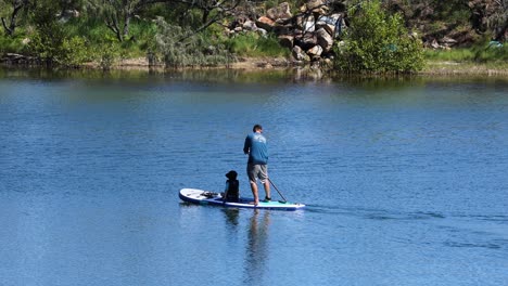 two people enjoying paddleboarding together on water