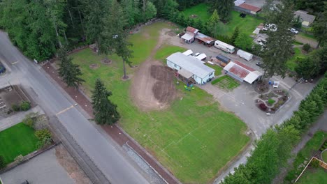 Orbiting-aerial-shot-of-an-old-mobile-home-on-a-cleared-property