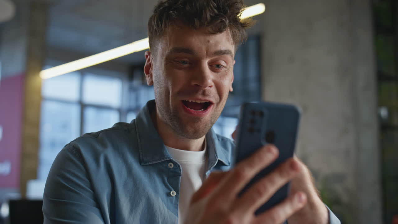 Man hands taking smartphone receive message with good news in office closeup