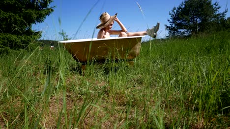 the girl with a hat in a bathtub