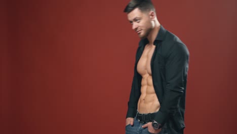 muscular young man in studio. strong muscular bodybuilder man with perfect trained body standing against background