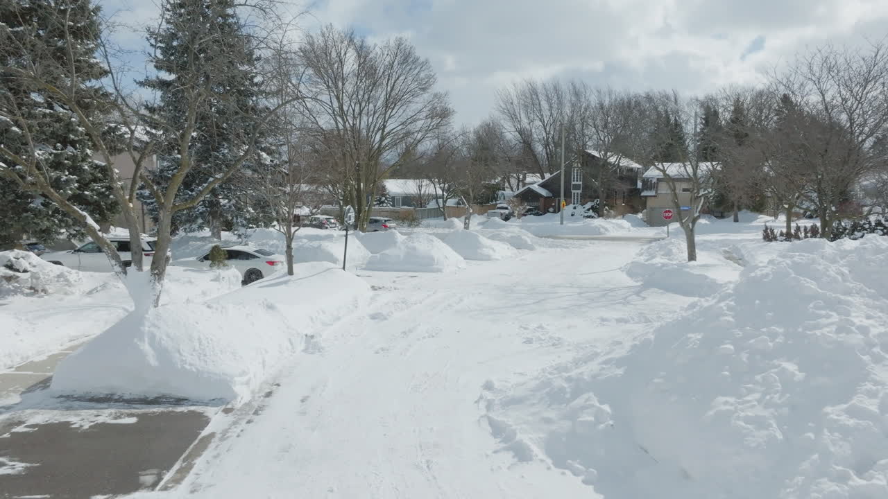 Snowy neighborhood on a sunny winter day with clear blue skies