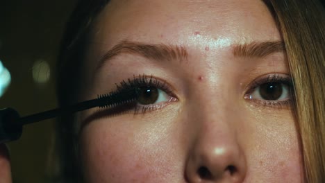 woman applying mascara