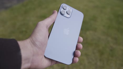 close-up of a blue iphone in a hand