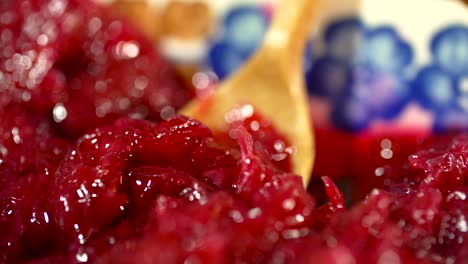 close-up shot of juicy crushed cherries, taking a spoonful of cherries