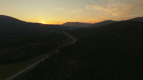 scenic midnight sun over mountains in e6 highway route in northern norway