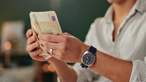 man counting euro banknotes