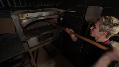 chef preparing pizza toppings in a restaurant kitchen