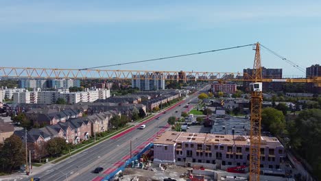 construction crane building residential housing development in dense urban city community with housing crisis