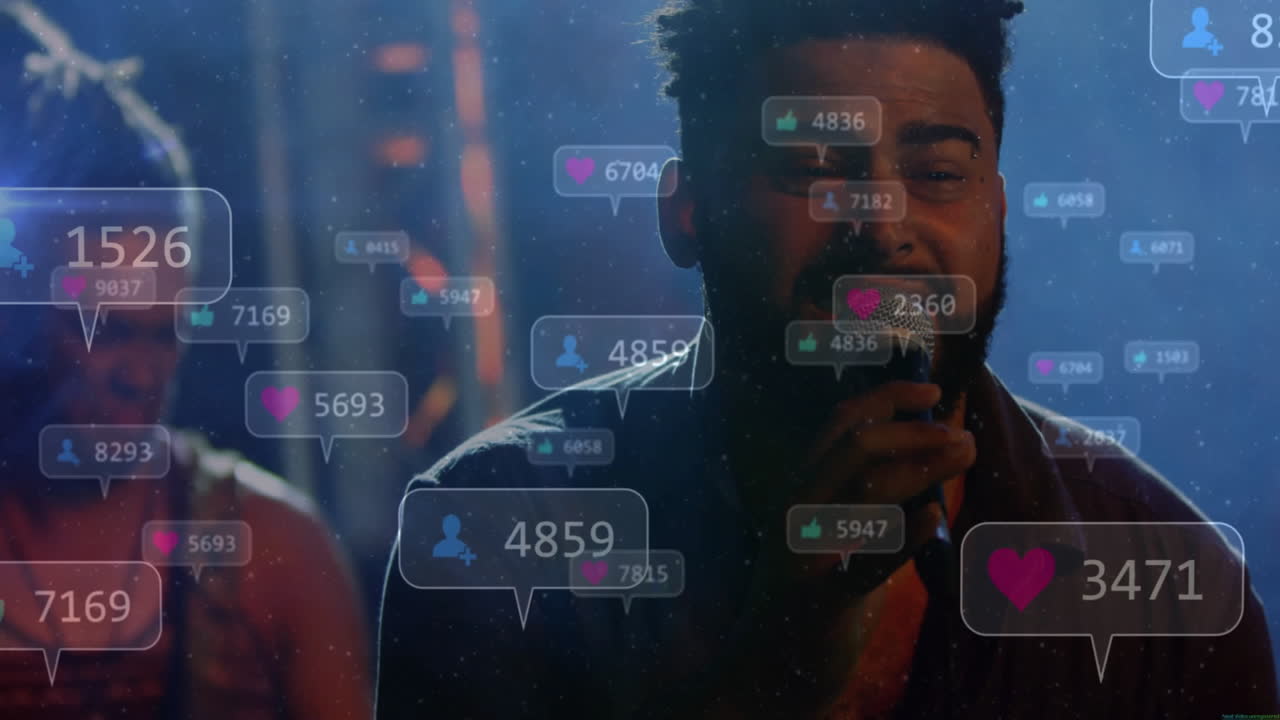 Singer gripping microphone on music stage in haze and spotlights, showing floating reaction icons