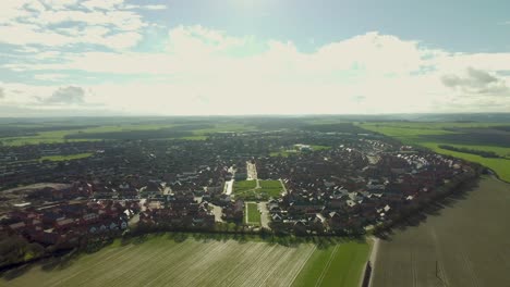 a drone reveal shot of the village of aylesham with the persimmon and barretts new build houses