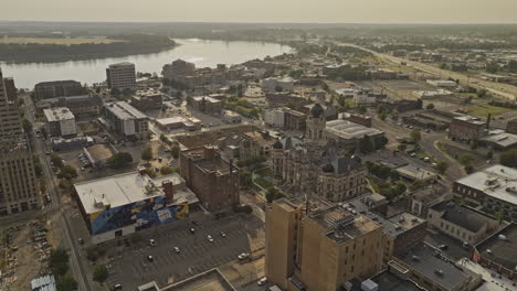 Evansville-Indiana-Aerial-v3-low-flyover-and-around-town-center,-featuring-historic-landmark-Old-Vanderburgh-County-Courthouse-and-river-views-at-sunset---Shot-with-Mavic-3-Pro-Cine---September-2023