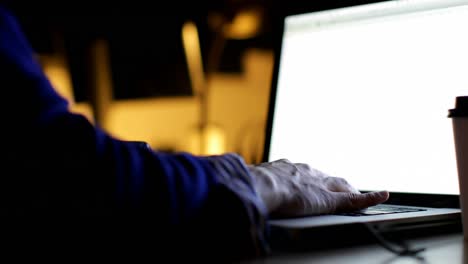 Close-up-of-male-executive-using-laptop-at-desk-4k