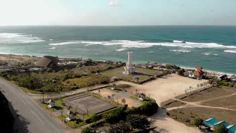 Aerial-view-on-lighthouse-and-coast-on-Pandawa-beach,-Bali,-Indonesia