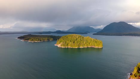 drone shot of tofino on vancouver island displaying autumn colors, rugged coastline, and ocean waves in a scenic aerial view.