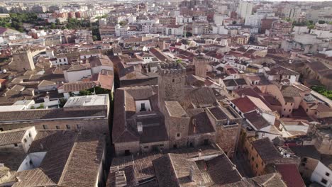 Aerial-orbit-around-strong-house-of-Palacio-de-los-Golfines-de-Arriba,-Caceres-Spain