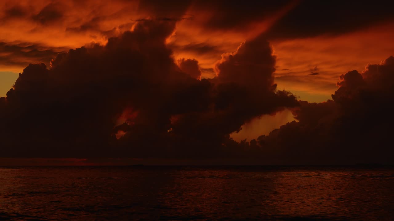 Time lapse of cloudy sunset over the sea in Istria with orange light reflecting on gentle waves