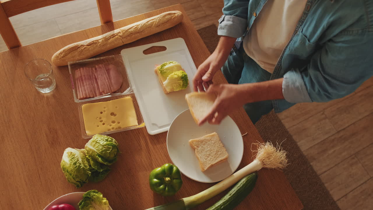 Man Making a Sandwich with Fresh Ingredients