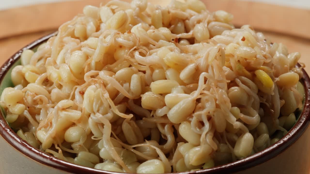 Salted soybean fermented in jar, chinese soy production, marinated food, germinated soy close up in cafe restaurant.